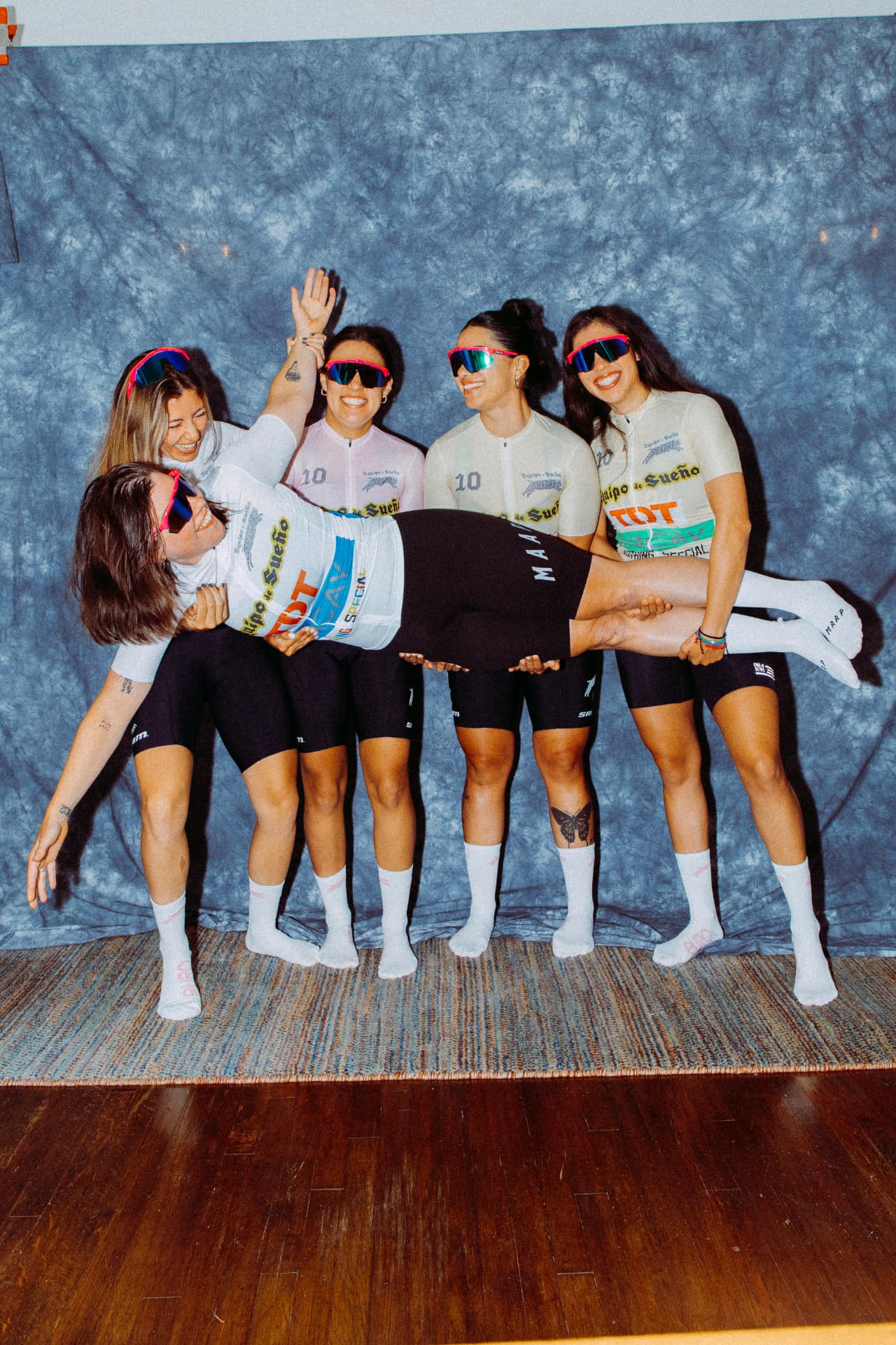 ELLAS riders carrying one teammate horizontally while laughing